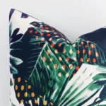 Close up image of top corner of this tropical colourful cushion. This shows the linen fabric and square shape up close.