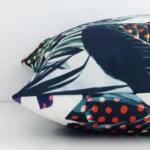 The seams of this linen square cushion cover in colourful prints are shown. The image shows the tropical design and how the panels are attached.