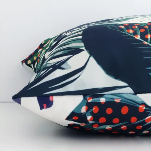 The seams of this linen square cushion cover in colourful prints are shown. The image shows the tropical design and how the panels are attached.