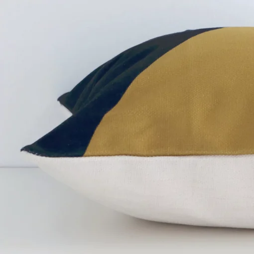 Side shot showing the seam of this square colourful cushion that features a geometric motif on its linen material.