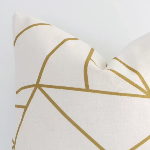 This image shows a golf mustard printed geometric cushion cover from a very close range. The square shape and linen material are more clearly shown.