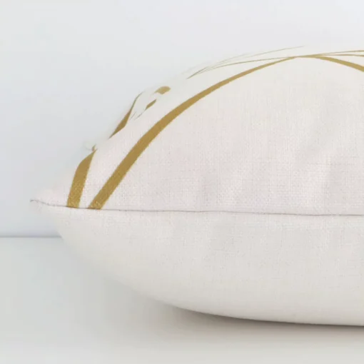 Horizontal edge view of front and back panels of a geometric linen cushion in a square size and with gold mustard print.