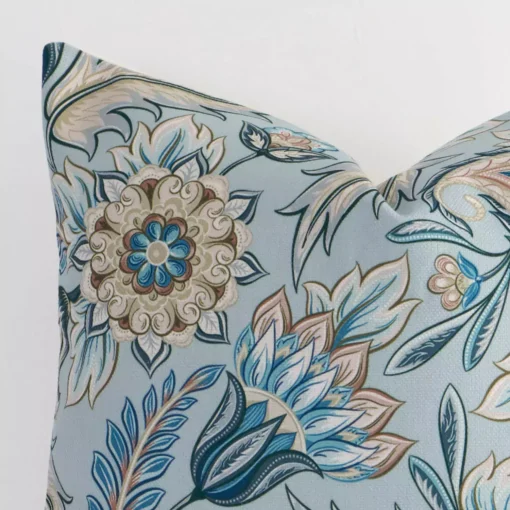 A close up image of this patterned square cushion. The image shows details of its linen fabric and colourful print.
