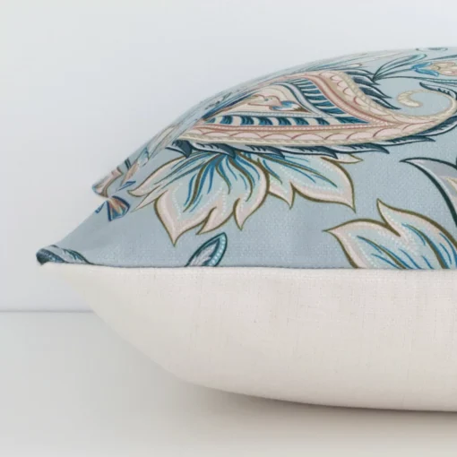 Side image of a linen square cushion cover. The patterned design and colourful print are visible from the side showing the attachment of the panels.