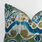 A close up shot showing the top left side of this square linen cushion cover. The colourful tone and patterned design are magnified.