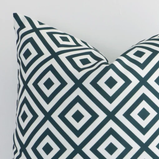 Extreme close up of a square green cushion. The geometric style and outdoor fabric are shown with a much higher degree of detail.
