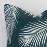 This image shows a green palm cushion cover from a very close range. The square size and outdoor material are more clearly shown.