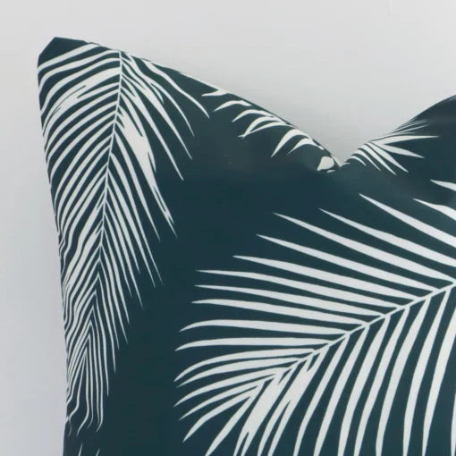 This image shows a green palm cushion cover from a very close range. The square size and outdoor material are more clearly shown.