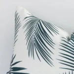 A close up image of this outdoor rectangle cushion. The image shows details of its outdoor fabric and palm colour.