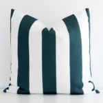 A pretty striped outdoor cushion cover is shown against a white wall. It features a large size and a green colour finish.