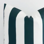 A close up shot showing the top left side of this large outdoor cushion cover. The green tone and striped design are magnified.
