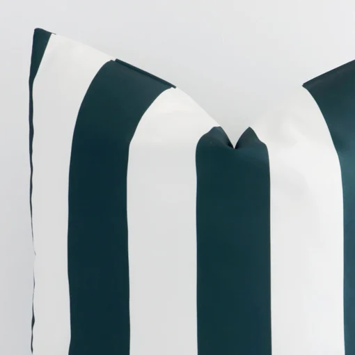 A close up shot showing the top left side of this large outdoor cushion cover. The green tone and striped design are magnified.