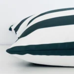 A large green cushion cover laying flat. This viewpoint highlights the stripe style and outdoor fabric from a side position.