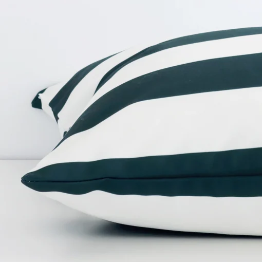 A large green cushion cover laying flat. This viewpoint highlights the stripe style and outdoor fabric from a side position.