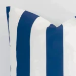 A very close image of the corner of a large outdoor cushion.The finer detail of the shape and navy colour are visible.