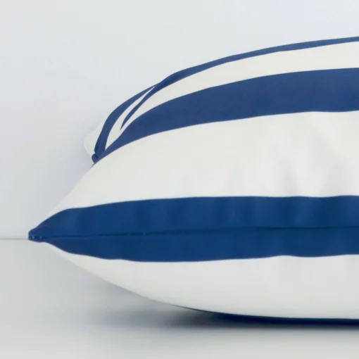 The seams of this outdoor large cushion cover in navy are shown. The image shows the striped design and how the panels are attached.
