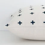 A square linen cushion positioned flat to show its seams. The black print colour and patterned design are visible as is the seam between the panels.