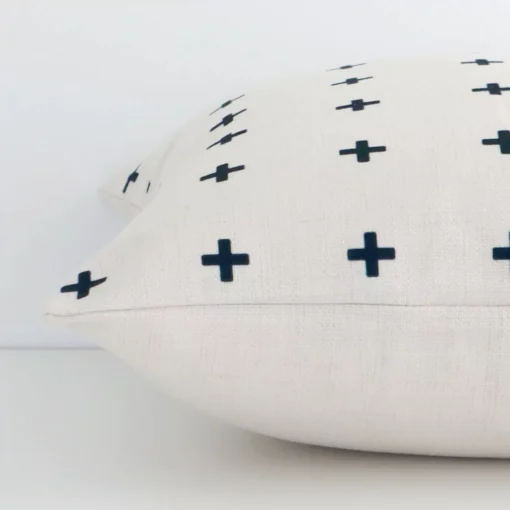 A square linen cushion positioned flat to show its seams. The black print colour and patterned design are visible as is the seam between the panels.