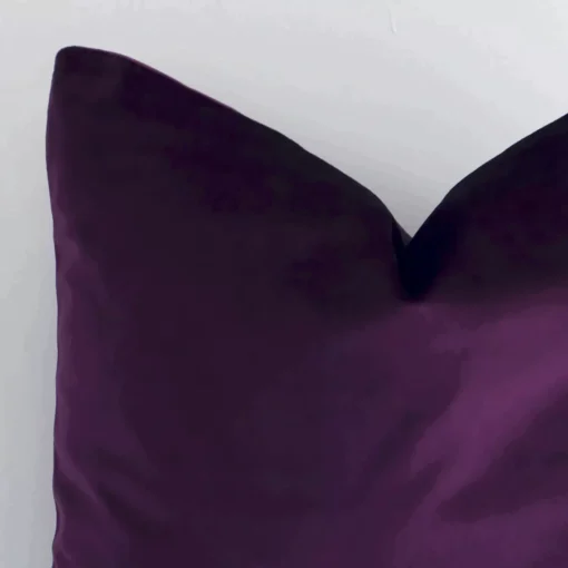 Very close photo of plum purple cushion. The shot shows the velvet material and square shape with more clarity.