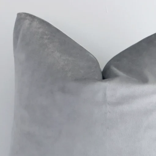 Zoomed in visual of velvet square cushion cover in silver. The intricacies of its solid-coloured design are visible.