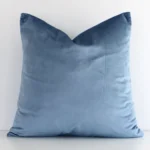 Charming stone blue solid-coloured cushion cover constructed from velvet fabric and shown in a square size.