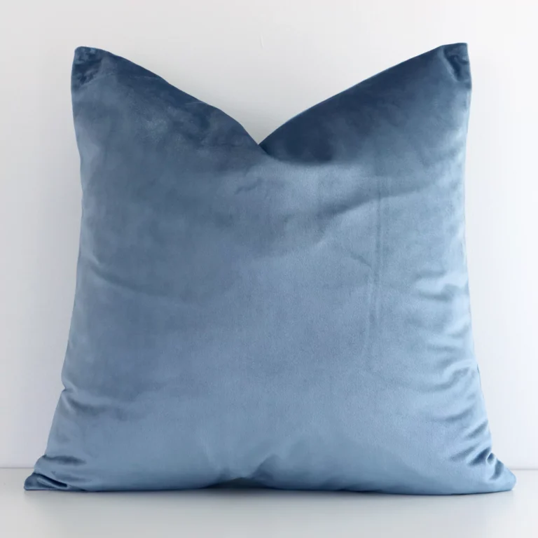 Charming stone blue solid-coloured cushion cover constructed from velvet fabric and shown in a square size.