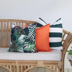 The Byron outdoor set of 3 sofa cushions is styled on a rattan seat.