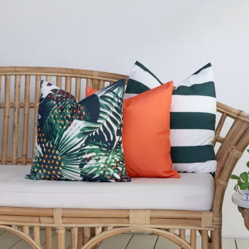 The Byron outdoor set of 3 sofa cushions is styled on a rattan seat.