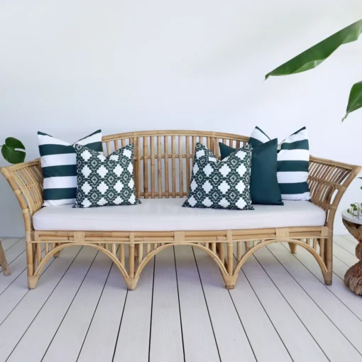 Set of 5 Byron green outdoor sofa cushions is styled on a rattan seat.