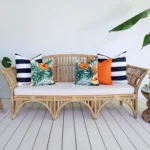 Orange and navy coloured cushions from the set of 5 Byron outdoor sofa cushions add beauty to a living room.