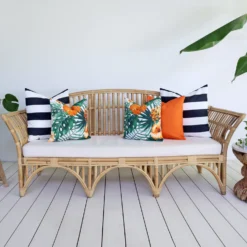 Orange and navy coloured cushions from the set of 5 Byron outdoor sofa cushions add beauty to a living room.
