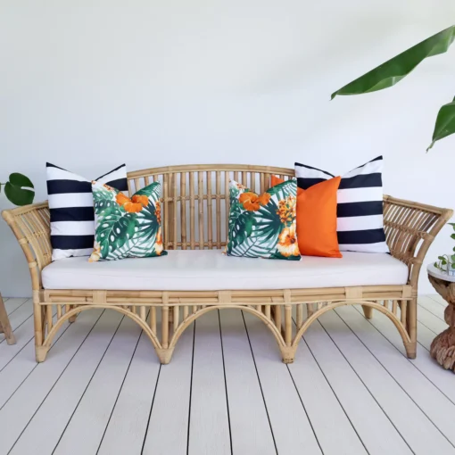 Orange and navy coloured cushions from the set of 5 Byron outdoor sofa cushions add beauty to a living room.