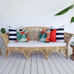 A set of 5 red outdoor sofa cushions from Byron collection are styled on a seat.