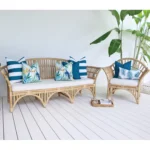 Set of 7 Green couch cushions in a bright outdoor living room that has a green plant.