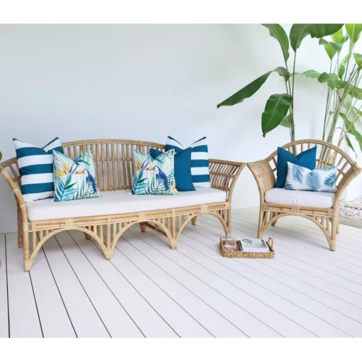 Set of 7 Green couch cushions in a bright outdoor living room that has a green plant.