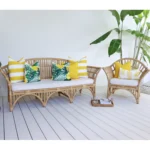Beautiful set of 7 yellow couch cushions on rattan seats in a bright outdoor living area.