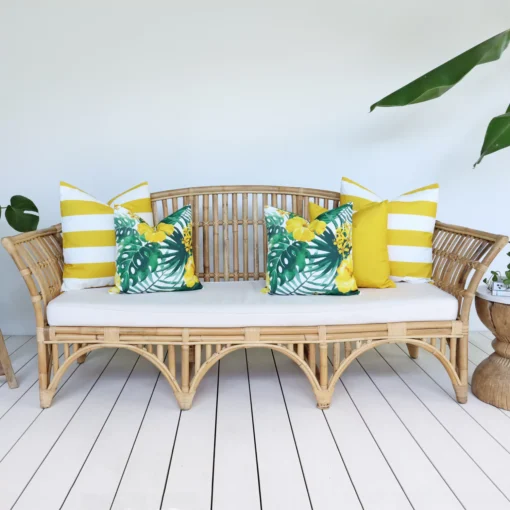 5 yellow outdoor sofa cushions on a rattan seat create a refreshing look.