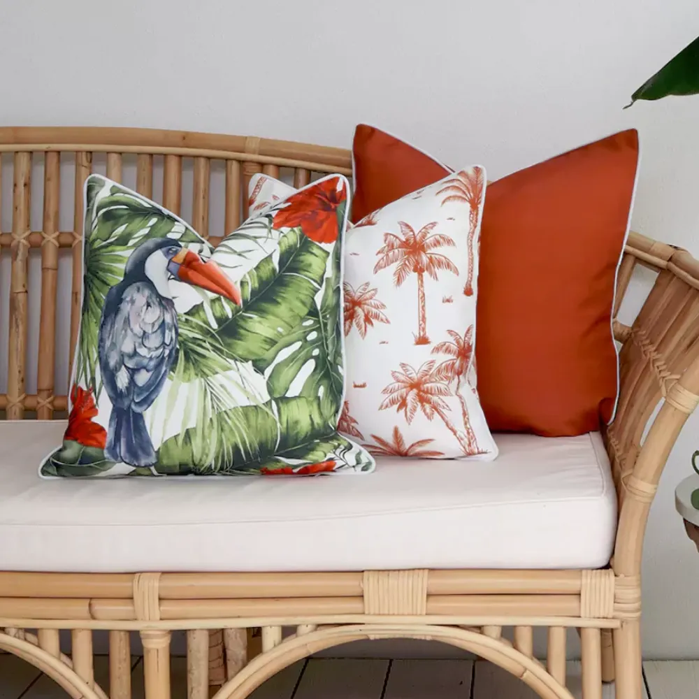 An arrangement of coordinated outdoor cushions is shown on a cane seat.