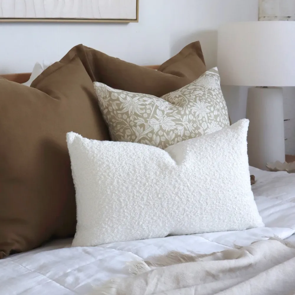 A boucle cushion sits styled as the feature piece of a classic set.