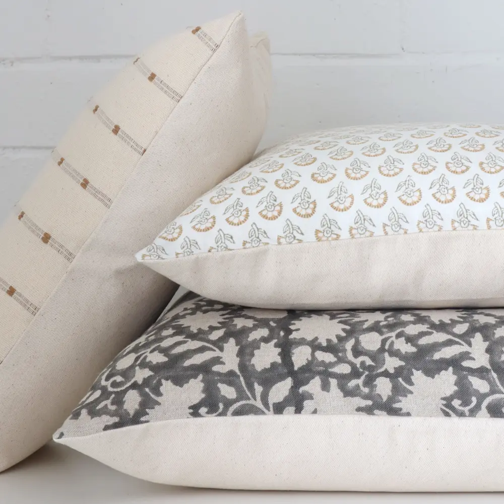 A detailed close up view of several premium Indian block printed cushions.