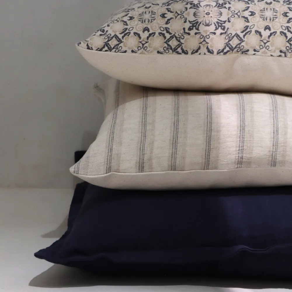 A coordinated cushion set with excellent combination of colour and pattern sits in some shadow.