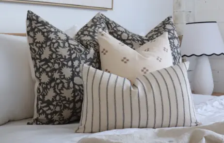 A coordinated cushion set displayed in a room with a lamp.