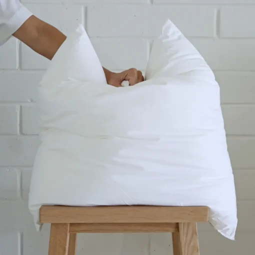 An insert being squashed from above by a hand showing its plumpness.