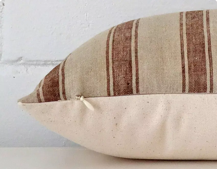 The side profile of a cushion is shown highlighting the quality of fabric, stitching and zip.