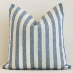 A premium outdoor blue cushion boasting a striped design and in a square size.
