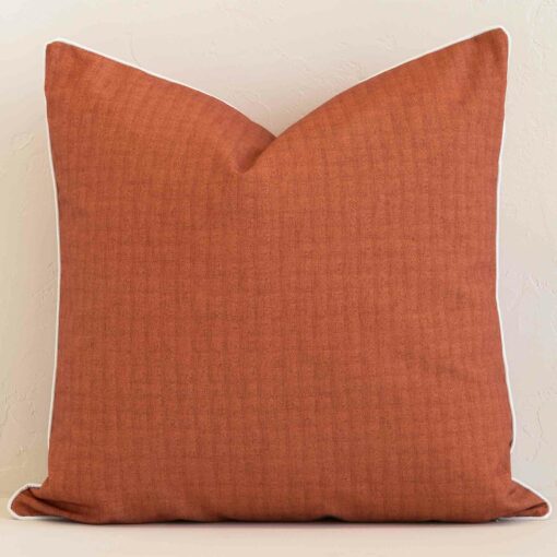 Vibrant solid-coloured rust cushion cover constructed from outdoor fabric and shown in a large size.