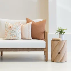 Outdoor seating with a set of 3 desert bloom outdoor couch cushions on it.