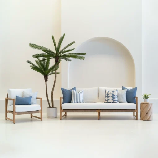 Living room scene with 7 pacific blue outdoor sofa cushions arranged on a white sofa.