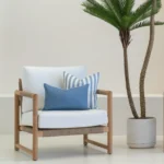 A wooden armchair with a pair of Pacific Cove outdoor cushions.