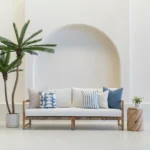 Living room scene with 5 sofa outdoor cushions arranged on a sofa.